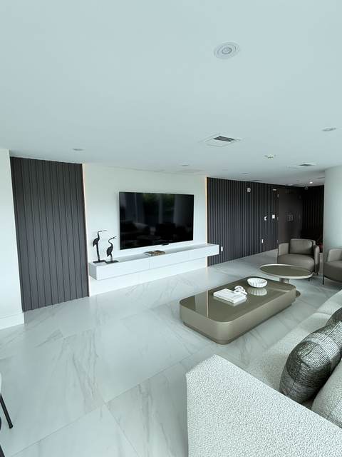 Black fluted wood feature wall with floating white TV console in a modern Miami living room