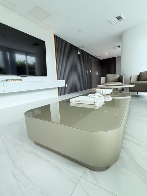 Open living room with black vertical slat paneling and marble-look porcelain floors
